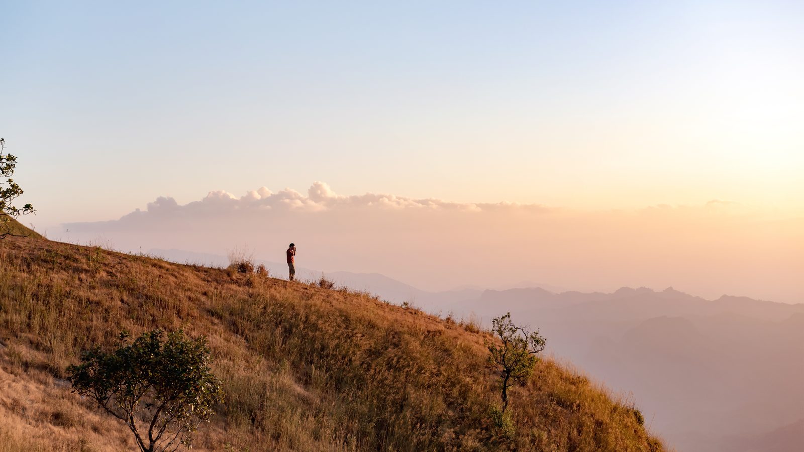 A hiker on a ridge in the last of the evening light